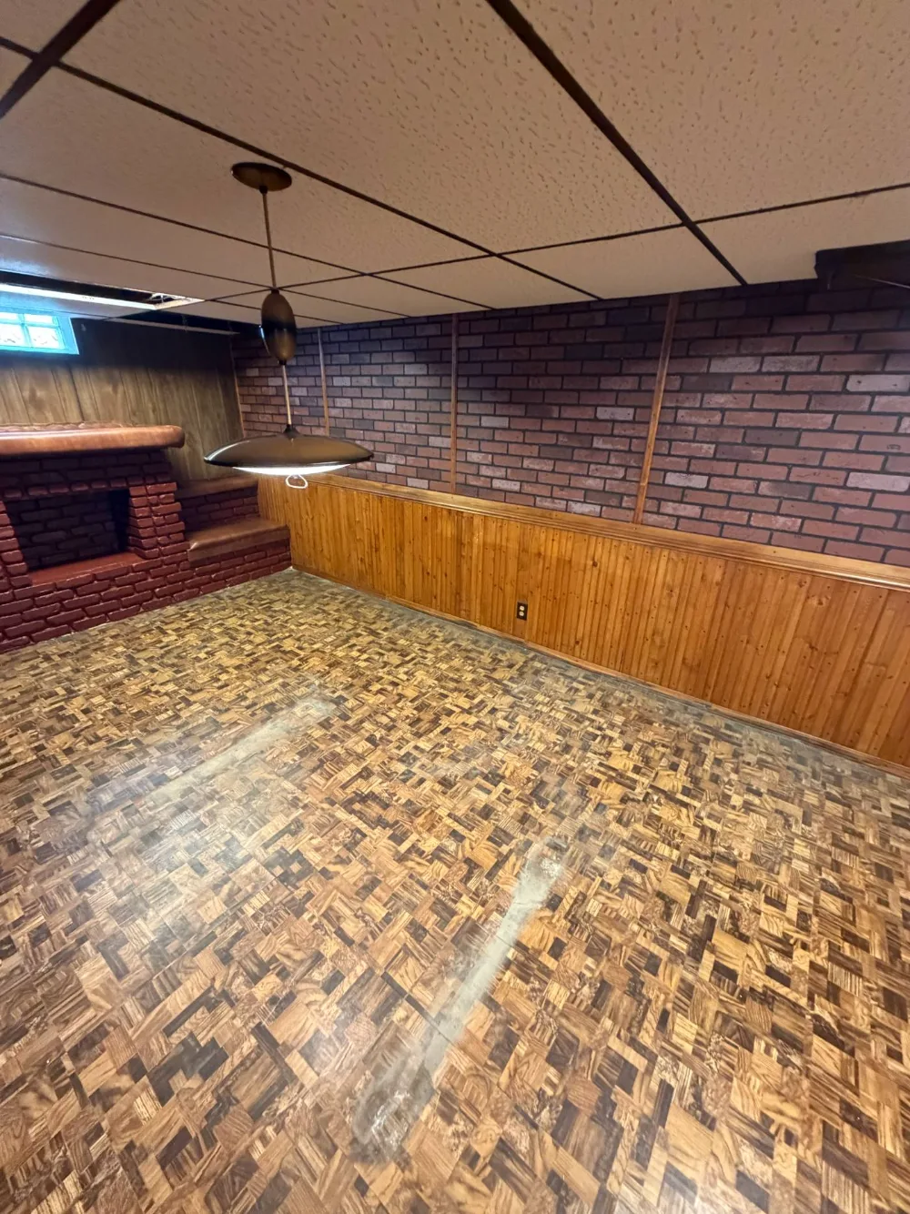 After: the same basement emptied, parquet floor clear